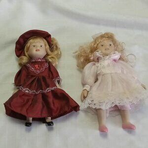 Two twelve-inch porcelain dolls, hands and faces in perfect condition, 2008
